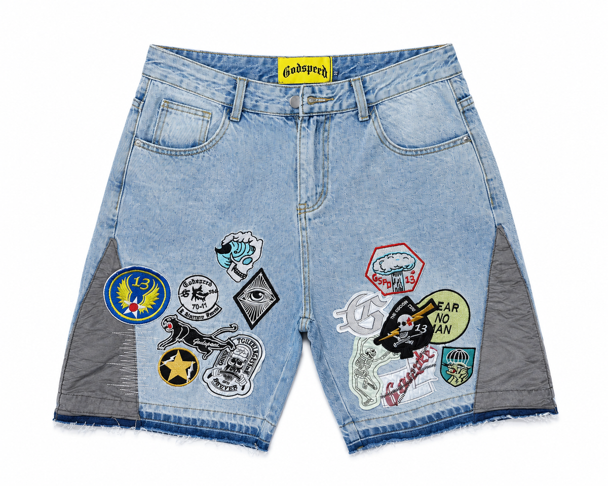 Godspeed Multi‑Patchwork Badge Light Wash Denim Jort Shorts